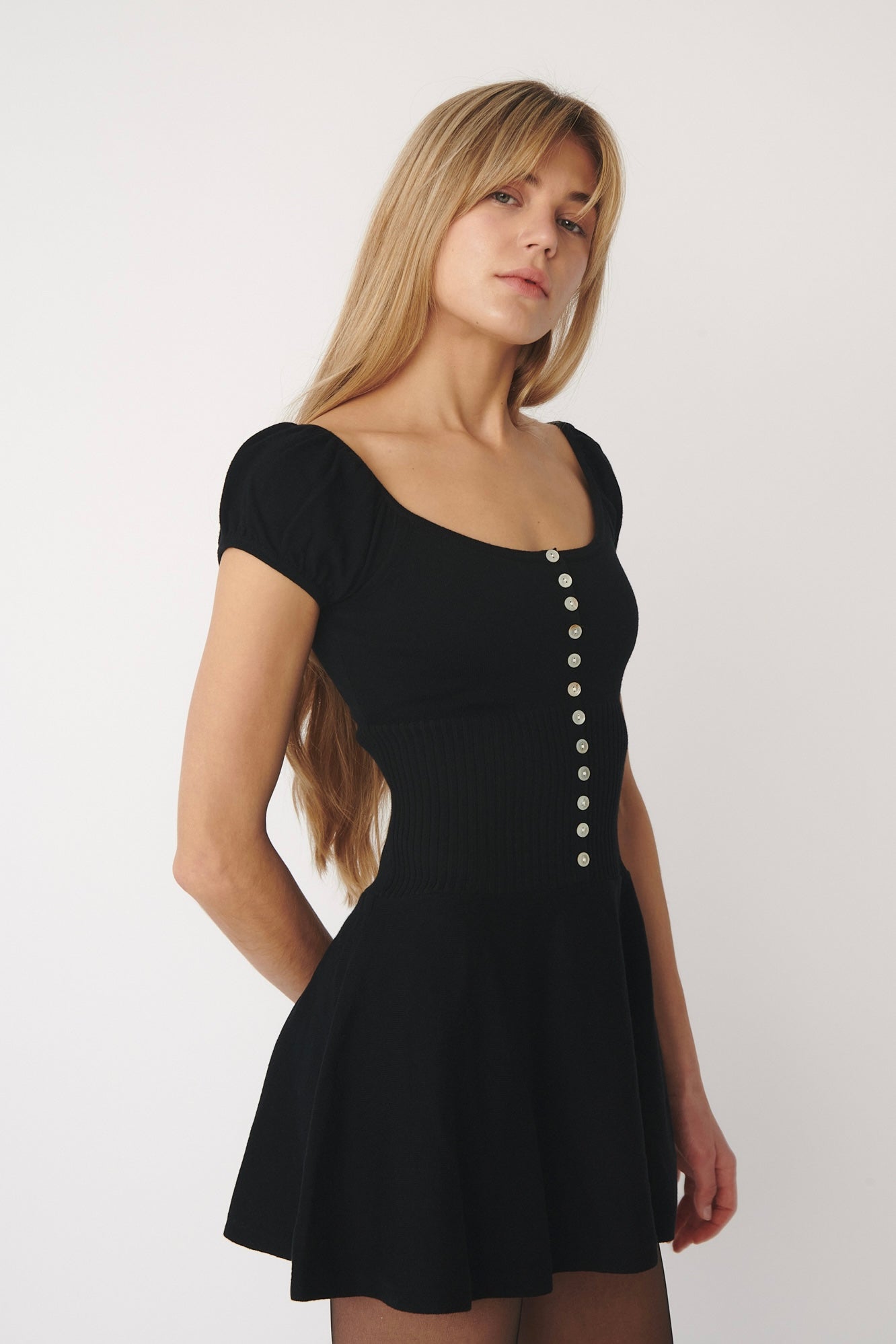 model wearing Lise knitted mini dress in black designed by A Room London