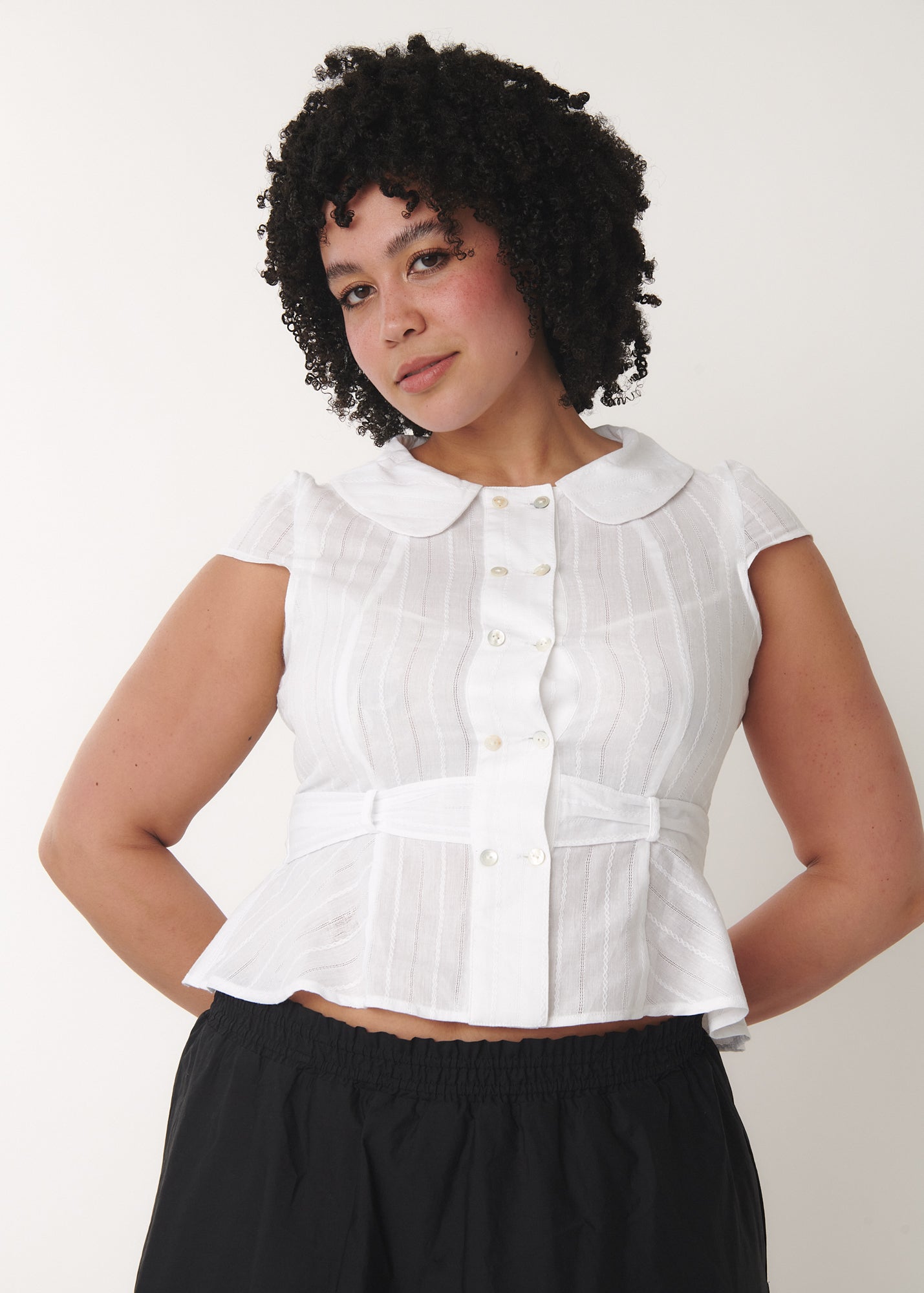 Model wearing the Virginia blouse in white in XL, featuring tailored waist design – by A Room London