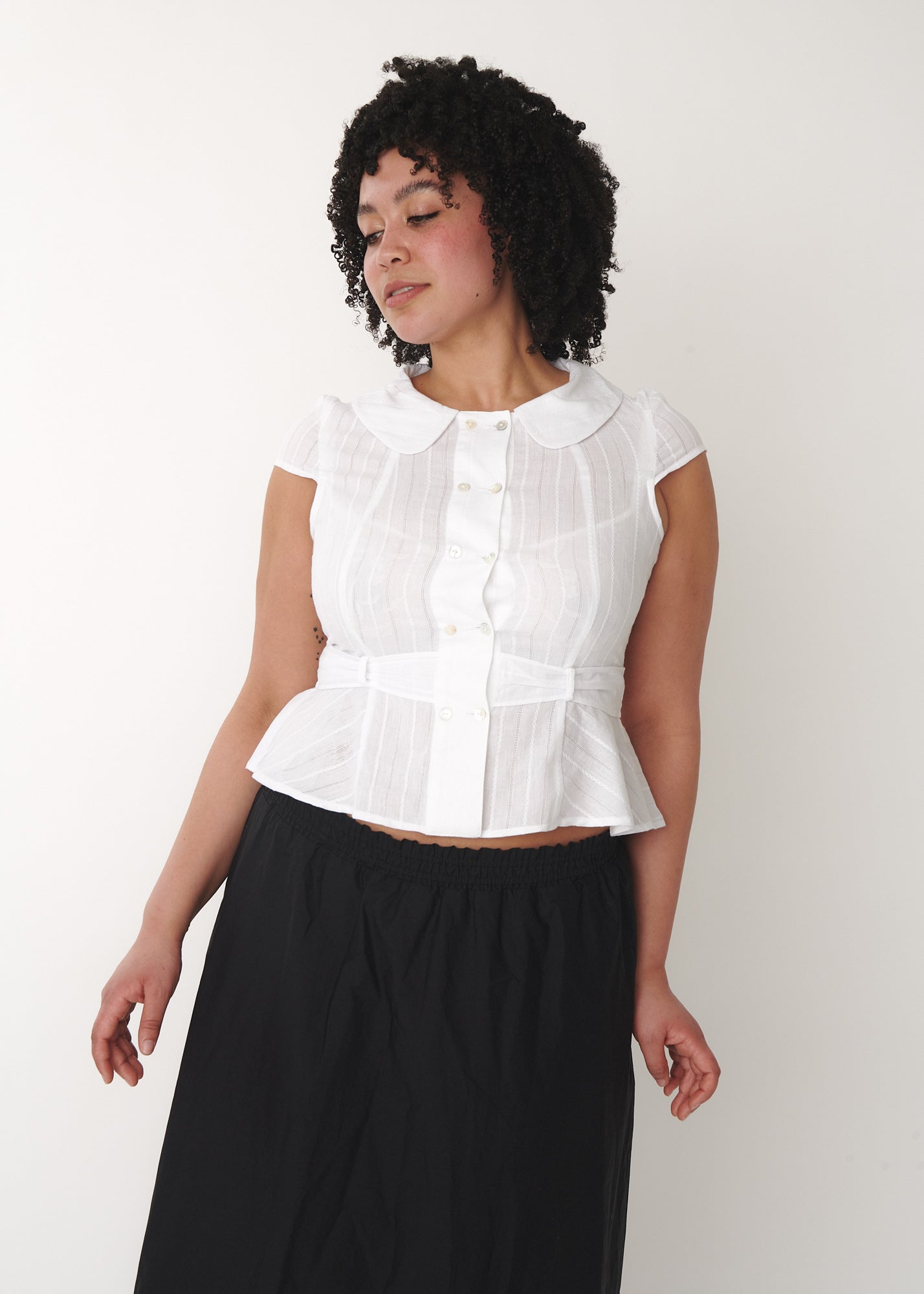 Model wearing Virginia Blouse in white, size XL, fitted cotton blouse with shell buttons – A Room London