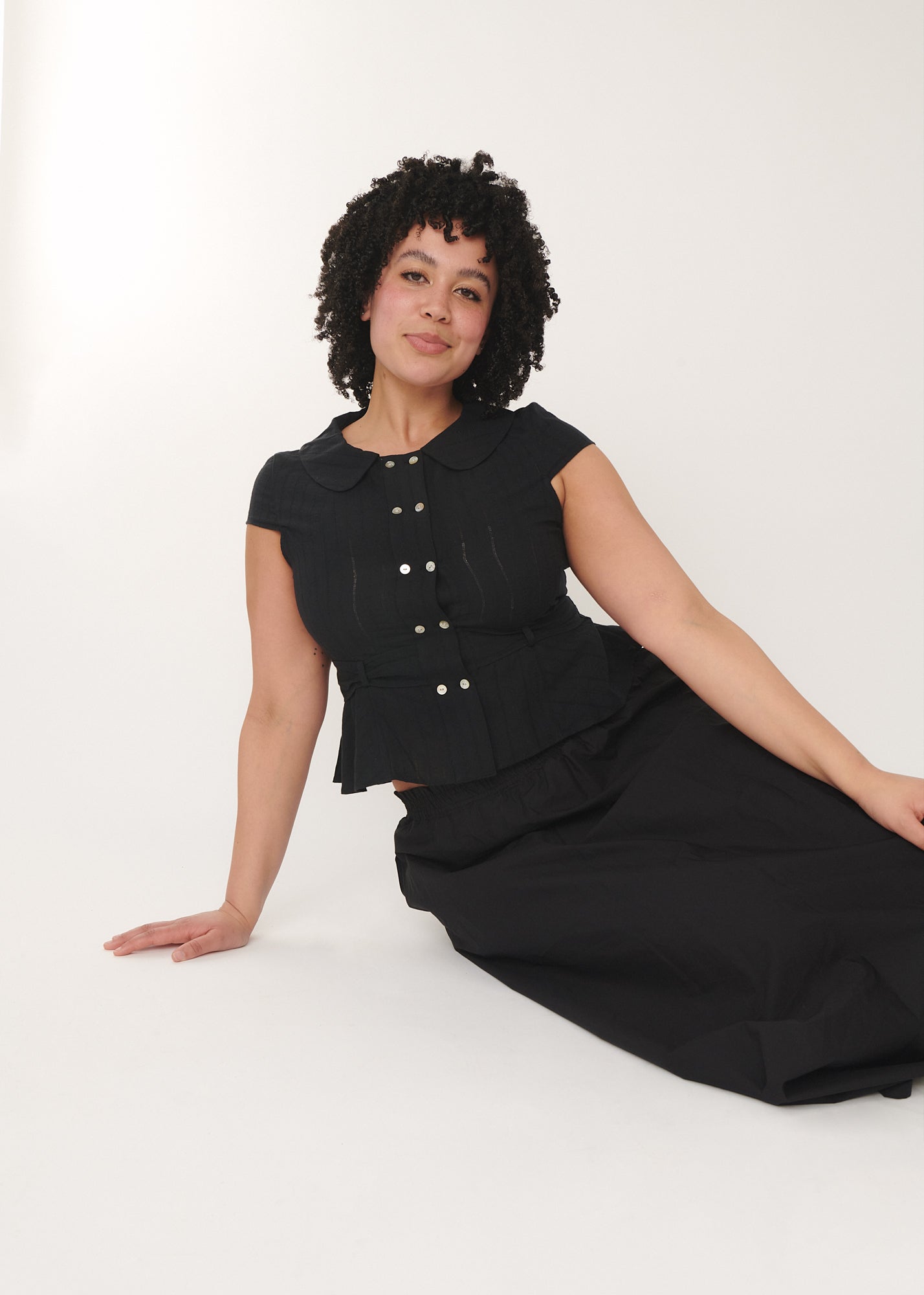 Model wearing the Virginia blouse in black, featuring breathable fabric– by A Room London

