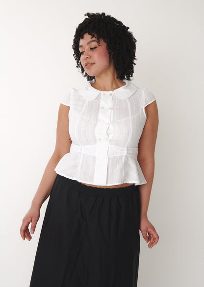 Model wearing Virginia Blouse in white, size XL, fitted cotton blouse with shell buttons – A Room London
